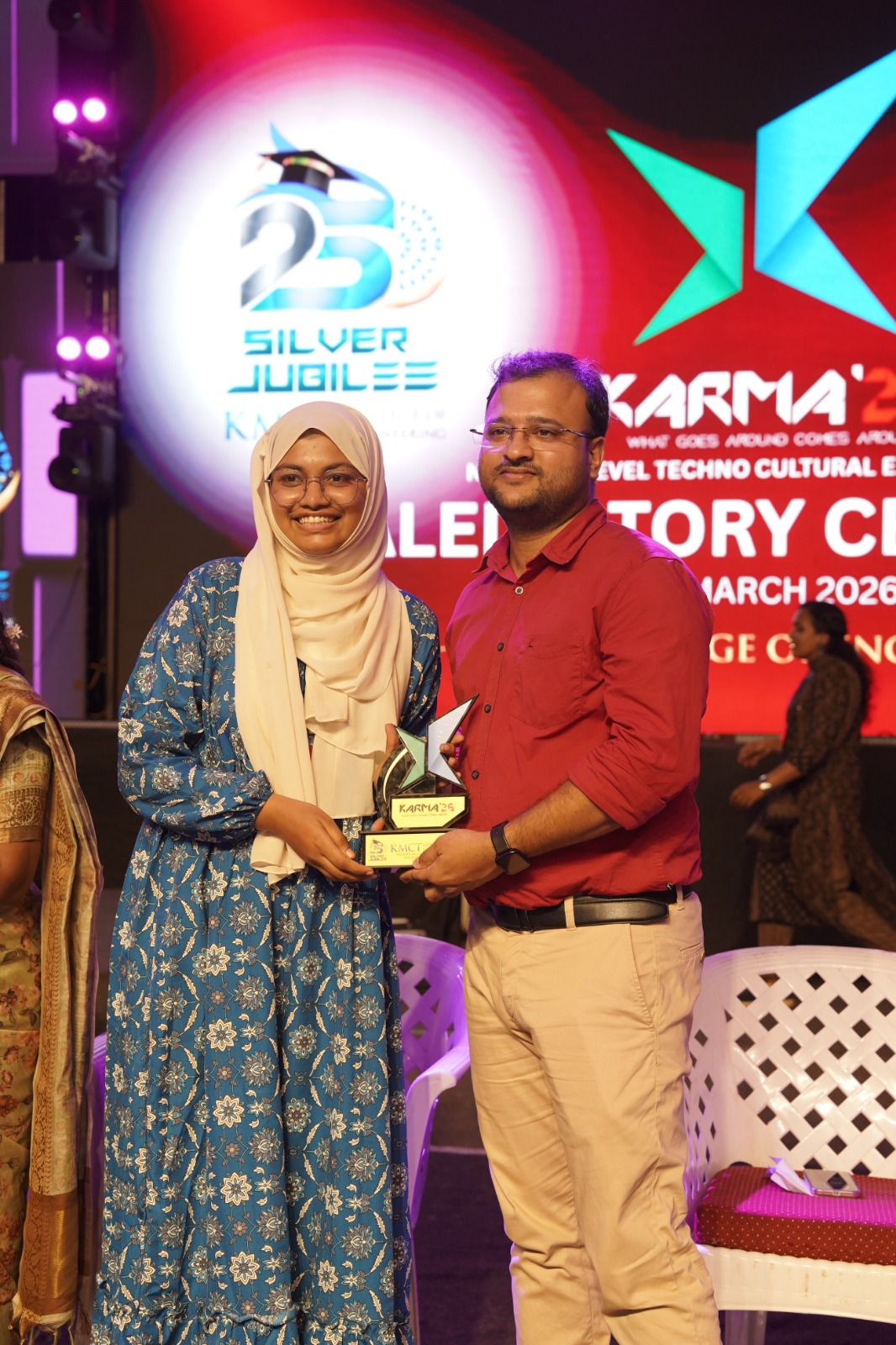 Aami receiving an award at Karma 25