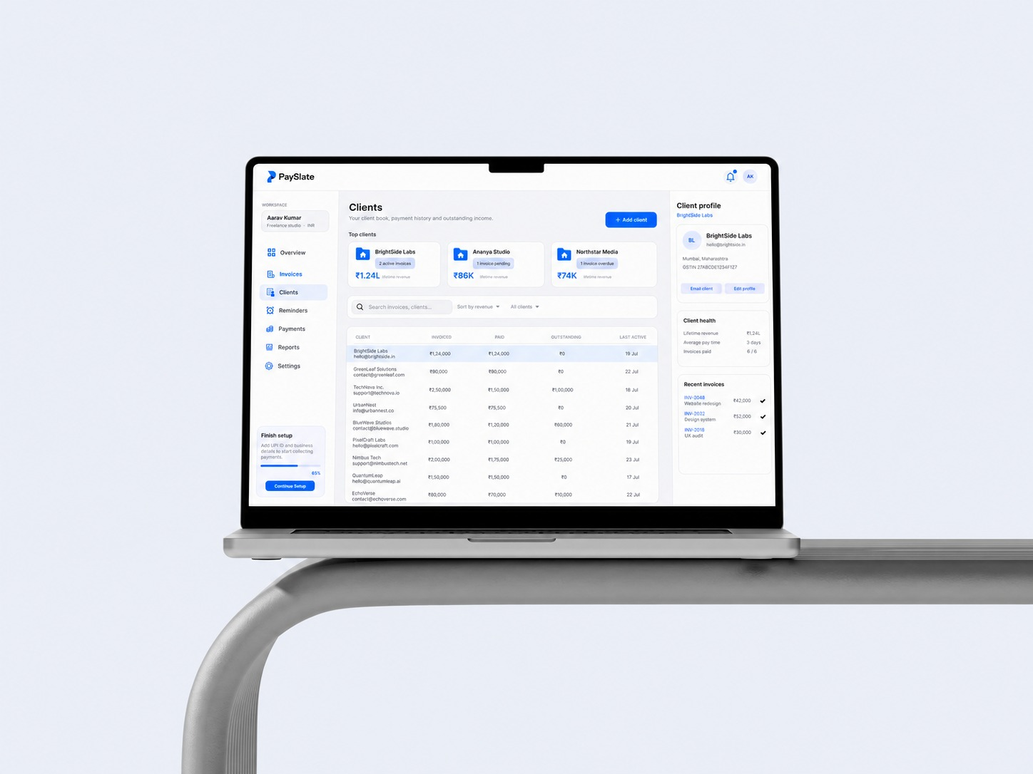 PaySlate client and invoice management interface displayed on a laptop
